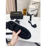 CHANEL puts on his boots with one foot