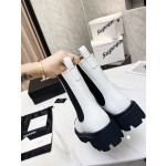 CHANEL puts on his boots with one foot