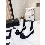 CHANEL puts on his boots with one foot