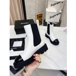 CHANEL puts on his boots with one foot