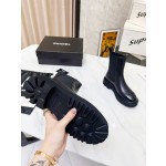 CHANEL puts on his boots with one foot