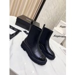 CHANEL puts on his boots with one foot