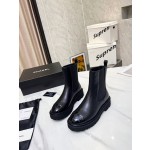 CHANEL puts on his boots with one foot